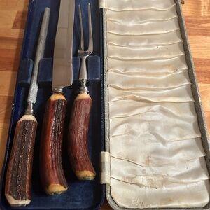 A vintage  Carving Set in Case- made with stag antlers-knife- fork- sharpener
